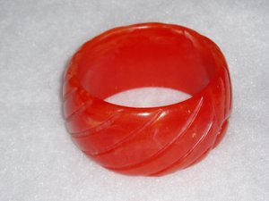 French Bakelite Galalith Galilith Bangle, Red-Orange Stylized Rising Sun Design